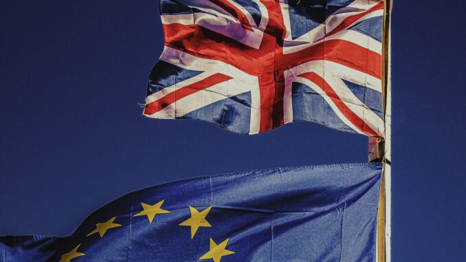 Flag of the UK flying above that of the EU as a techUK report warns the government must act to maintain semiconductor industry leadership to deliver economic growth, support its wider industrial strategy, and match global investments like the European Chips Act.